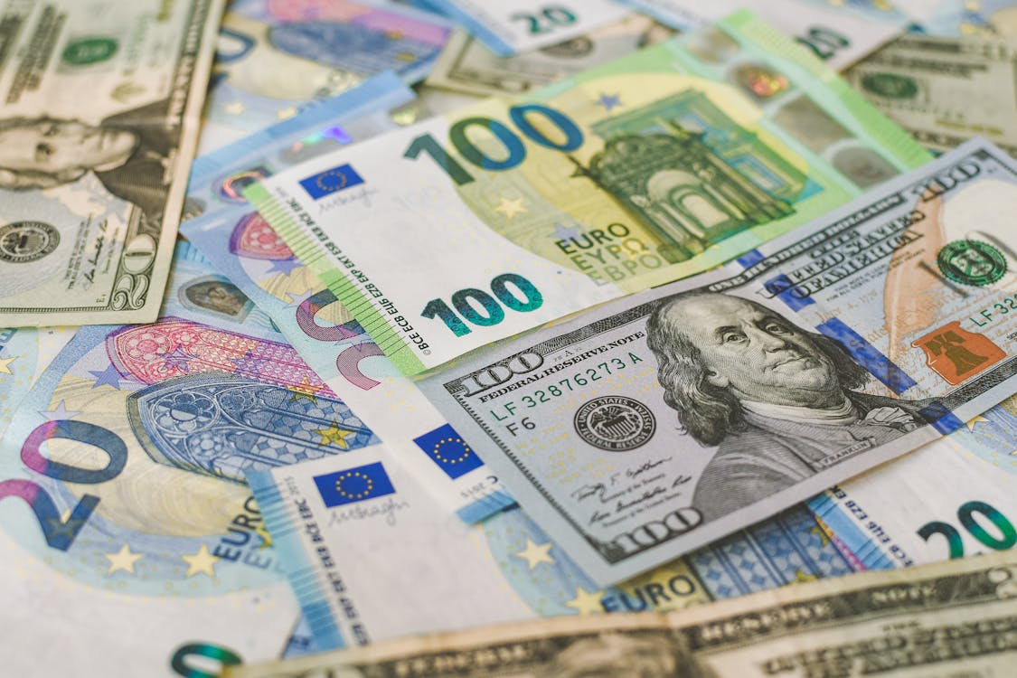 Close-up of mixed US dollar and euro banknotes, illustrating global currencies and international finance.