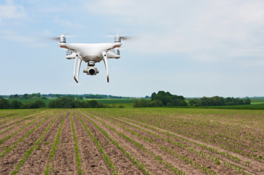Drone flying over crop field using precision agriculture technology to improve food security.
