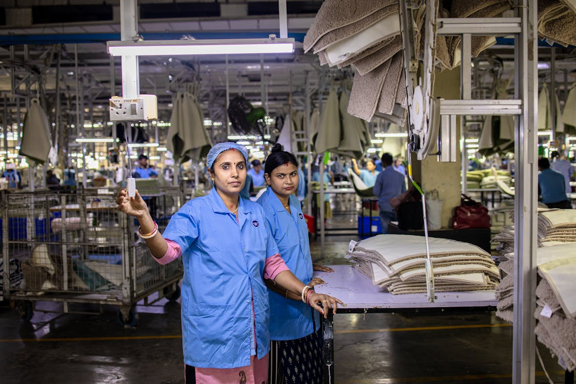 Female garment workers in a textile factory in a developing country, highlighting labor conditions behind fast fashion.