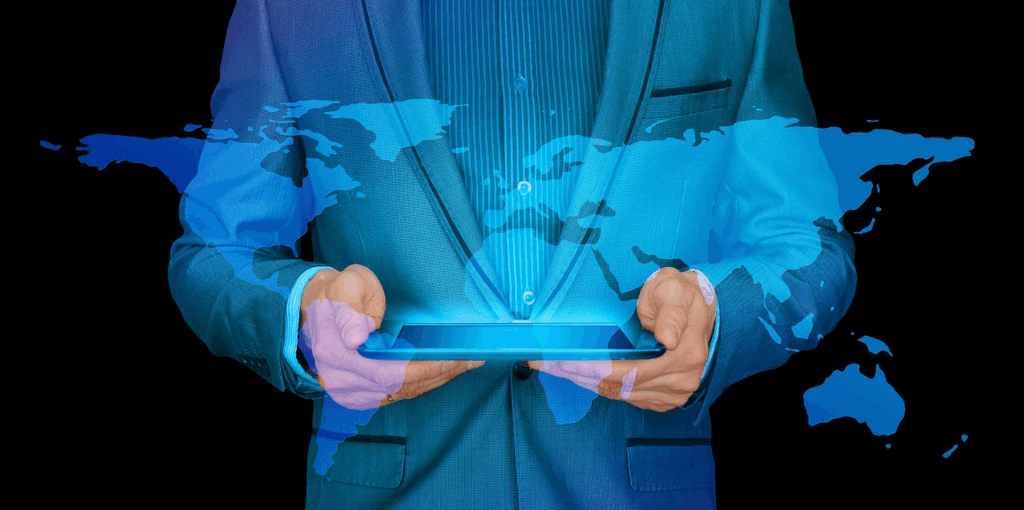 Business person holding a digital tablet with a world map overlay, symbolizing global tech giants and worldwide innovation.